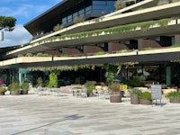 a restaurant with tables and chairs in front of a building