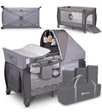 a grey baby cot with a bag and a changing table