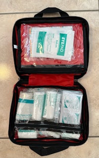 a first aid kit with several items in it