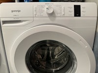 a white washing machine is sitting next to a dryer