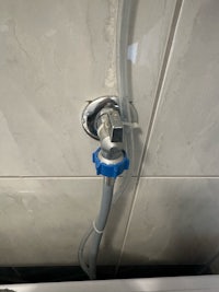a shower head with a blue hose attached to it