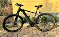 an electric bike is parked in front of a brick wall