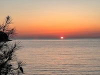 a blurry image of a sunset over a body of water