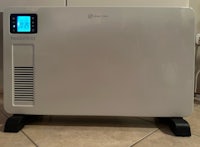 a small electric heater sitting on a table in a kitchen