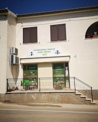 the front of a building with a green sign