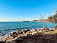 a view of the ocean from a rocky shore