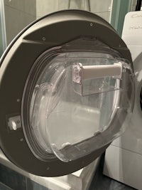 a 3d model of a washing machine in a bathroom