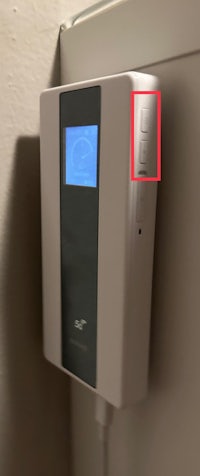 a wall mounted device with an arrow pointing to it