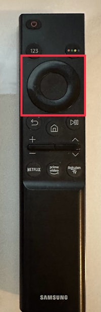 a samsung tv remote with a red circle on it