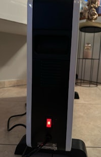 a black and white computer with a red light on it